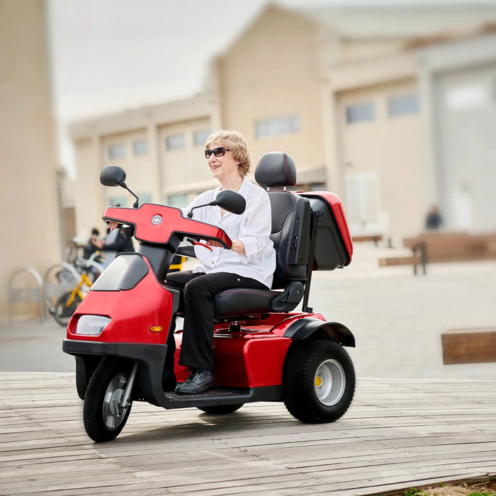 AFIKIM Afiscooter S3 3-Wheel Electric Mobility Scooter - Heavy Duty Scooter - Red Color with woman riding in the City - Afikim Drive