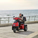 AFIKIM Afiscooter S3 3-Wheel Electric Mobility Scooter - Heavy Duty Scooter - Red Color with woman riding in the Beach- Afikim Drive
