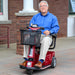 A man sitting on the red Amigo RT Scooter