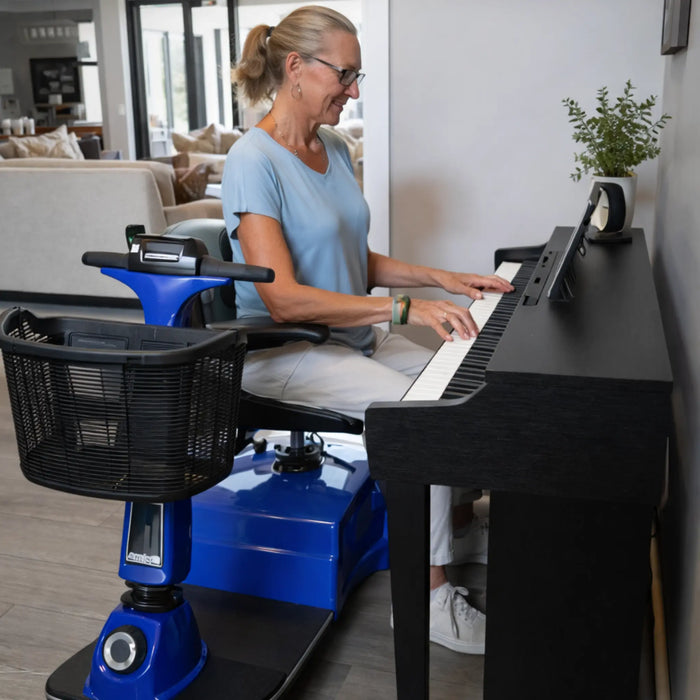 A woman sitting on a swivled chair of the Amigo RD Scooter while playing her piano 