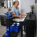 A woman sitting on a swivled chair of the Amigo RD Scooter while playing her piano 