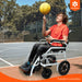 Person in a Bangeran Phoenix kids electric wheelchair balancing a basketball on their hand on a basketball court, with 'Bangeran' logo visible.