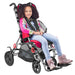 Circle Specialty Strive Adaptive Pediatric Stroller - With Girl Sitting on the Stroller