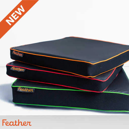 Stack of Feather brand mattress toppers with color accents on a gray background