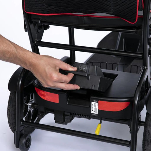 Person interacting with a black and red Feather Mobility Scooter Battery