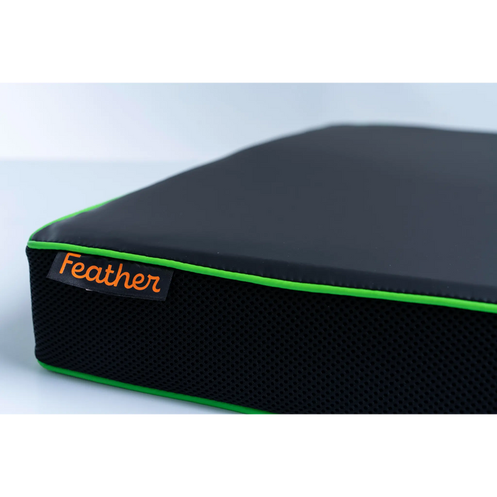 Black and green feather wheelchair cushion 22" with 'Feather' brand label on a light gray background