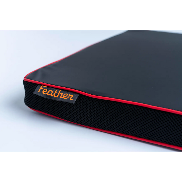 Black and red mat cushion with 'Feather' branding on a light gray background