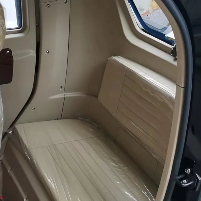 Gio Golf Back Seat Beige interior of a vehicle with a bench seat and door open