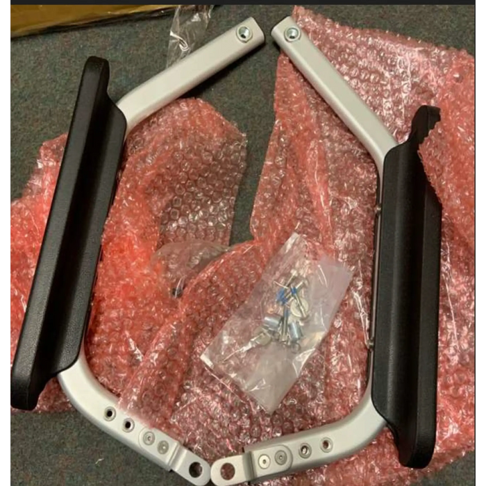 Metal frame with black handles on a red bubble wrap background The Journey Zoomer Handrail Set includes the right and left armrests