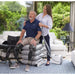 Mangar Elk Portable Patient Lifting Cushion with a sitting patient and a caregiver