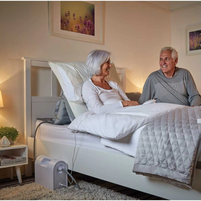 Mangar Handy Inflatable Pillow Lift with Airflo 12 Compressor showing it being used to stay upright in Bed
