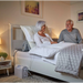 Mangar Handy Inflatable Pillow Lift with Airflo 12 Compressor showing it being used to stay upright in Bed