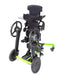 Black and green mobility device on a white background Allows self-propulsion while sitting or standing. Push rims adjust forward and aft. Mobile footprint 