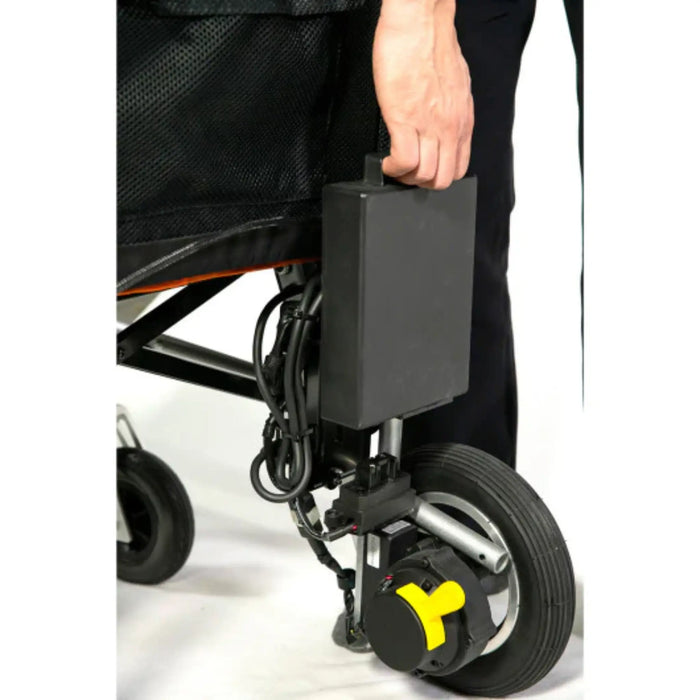 Close-up of a wheelchair with a power battery attached, showing a person's hand holding onto it for the feather 33lbs wheelchair