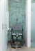 Shower with a disabled shower chair against a mosaic tiled wall. Seatara BathMobile in the Shower commode