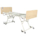 CostCare BC320 long-term care bed raised to higher working height with adjustable frame and caster base for mobility
