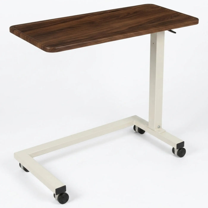 CostCare BZT330 long-term care overbed table with walnut woodgrain tabletop, adjustable-height support column, and caster wheel base.