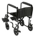 Rear three-quarter view of the black Drive aluminum transport chair with folding back, wheel locks, and footrests.