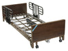 Drive Delta electric medical bed shown without a mattress and fitted with half side rails