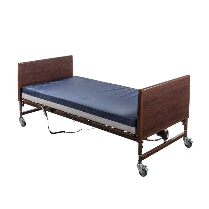 Drive full electric homecare bed shown flat with a blue mattress in a side three-quarter view