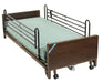 Drive full electric low bed with a gray-green mattress and full-length side rails