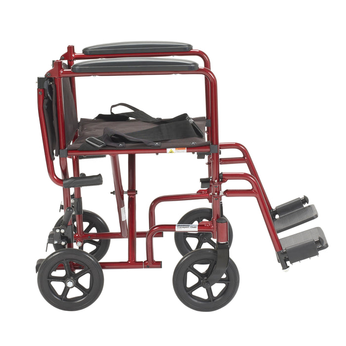 Red Drive Lightweight Transport Chair in side view with the folding back lowered for compact storage.