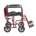 Red Drive Lightweight Transport Chair in side view with the folding back lowered for compact storage.