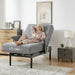 Senior woman relaxing in the EZLift Bed Deluxe Sleep To Stand Bed in Recliner Position, with the backrest elevated and leg section raised to provide comfortable support for resting and leisure activities.