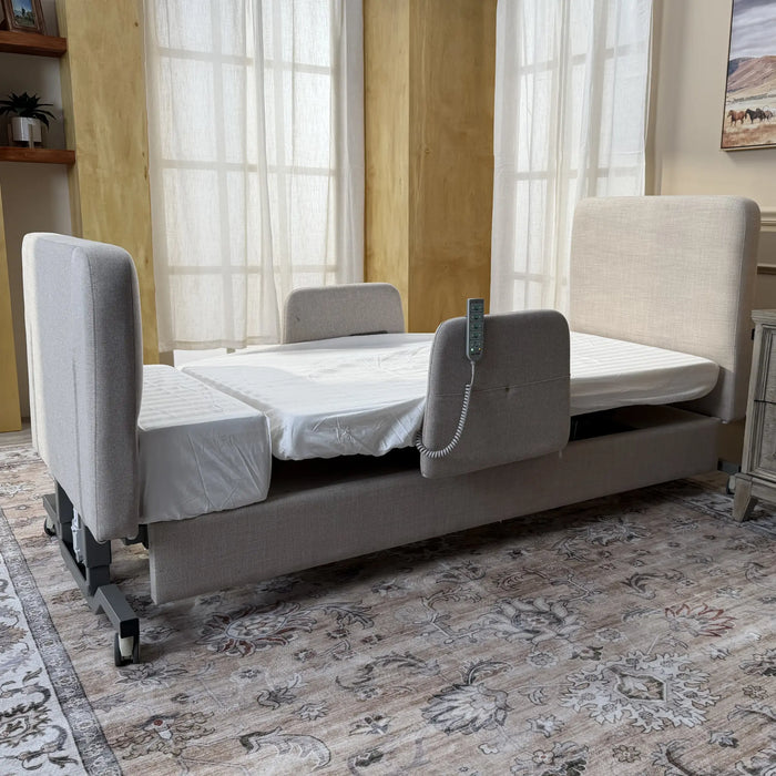 EZLift Bed Elevra Deluxe Rotating Hi-Lo Lift Bed installed in a home bedroom setting, shown in its standard flat sleeping position with remote control attached.