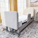 Rear corner view of the EZLift Bed Elevra Deluxe Rotating Hi-Lo Lift Bed showcasing the upholstered headboard, adjustable frame, and mobility casters.