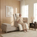Older adult seated comfortably in the chair position of the EZLift Bed Elevra Rotating Adjustable Bed in a modern bedroom, demonstrating safe transfer and standing assistance.
