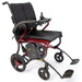 Forcemech Ultralite G20 Pro carbon fiber folding power wheelchair in red, shown at an angle with joystick control, padded black seat, compact wheels, battery pack, and footrests.