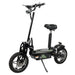 Angled front-side view of the green GIO Cobra foldable seated electric scooter showing foldable handlebars, rugged wheels, rear suspension, and padded seat on a white background.