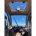 Upward interior view of the GIO Enclosed Mobility Scooter featuring panoramic roof skylight and enclosed cabin ceiling.