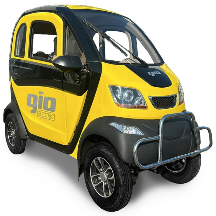 Yellow and black GIO Enclosed Mobility Scooter with enclosed weather-protected cabin, front bumper guard, and compact electric mobility vehicle styling.