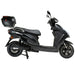 Side profile view of the black GIO Phoenix PR Moped-Style Electric Scooter featuring rear cargo box, long padded seat, alloy wheels, and step-through electric scooter frame.