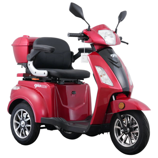 Studio image of the red GIO Regal 3-Wheel Mobility Scooter with a windshield, showing the padded seat with armrests, rear cargo compartment, LED front lights, and sporty three-wheel design.