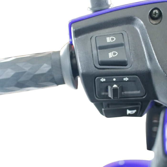 Close-up of GIO Tron Pro scooter handlebar controls showing headlight switches, turn signal controls, and horn button.