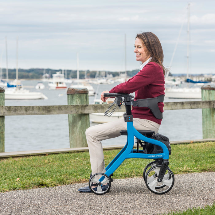Nitro Sprint Rollator, Blue, side view with a woman sitting on it