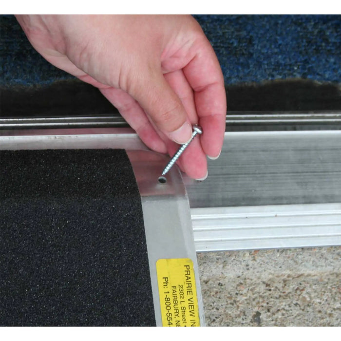 Close-up of PVI bariatric threshold ramp with screw placement hole for securing the ramp at a doorway