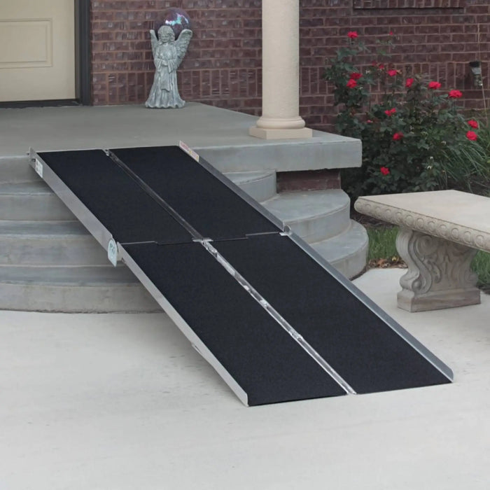 PVI multifold ramp installed over front steps with black traction surface for wheelchair or scooter access