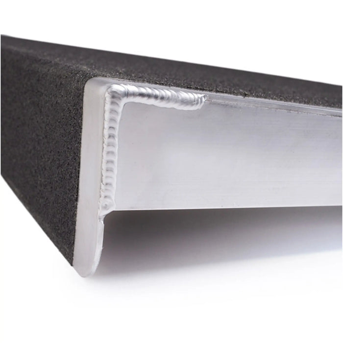 Close-up of PVI self-supporting threshold ramp showing aluminum side support and textured ramp surface