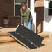 PVI singlefold threshold ramp being folded and positioned on outdoor steps for entry access