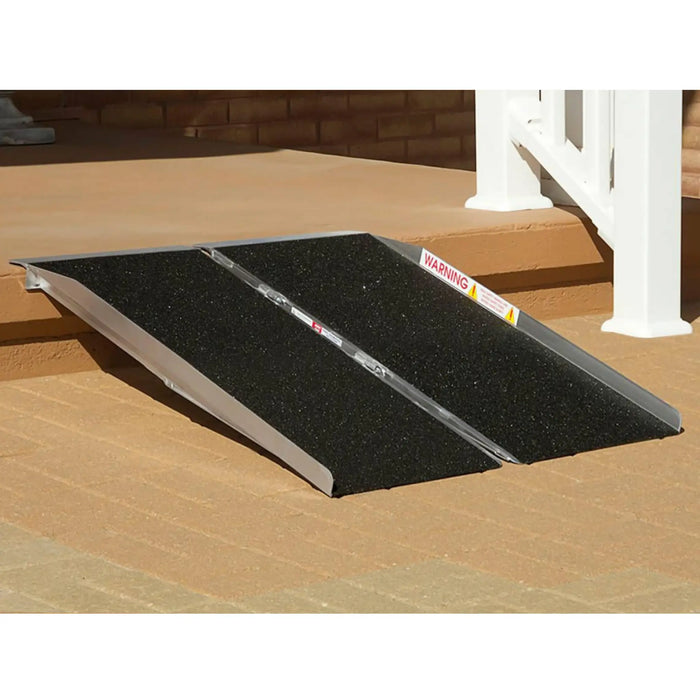 PVI singlefold threshold ramp placed over front steps providing smooth access for wheelchair or scooter