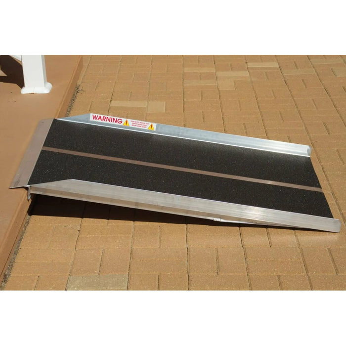 PVI solid ramp installed at a raised threshold with black traction surface and aluminum side rails
