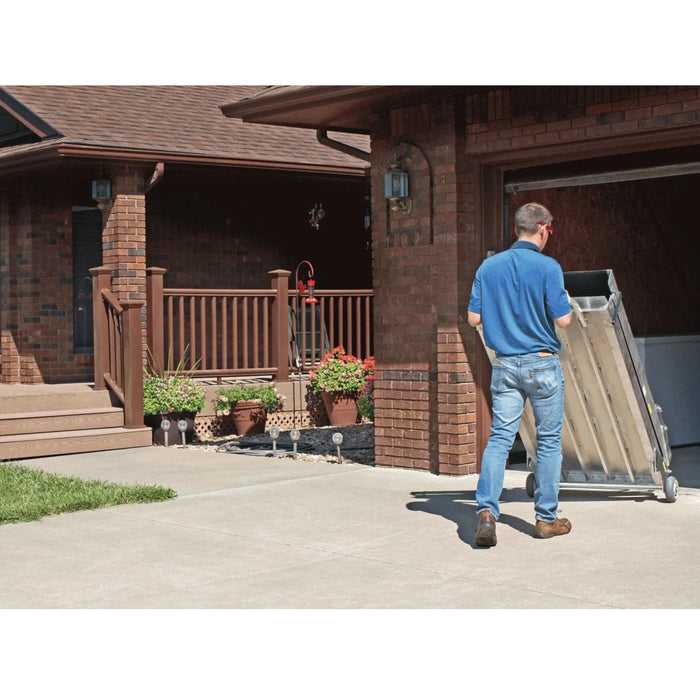 PVI Wheel-A-Bout ramp being rolled into a garage using built-in wheels for easy transport and storage