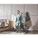 Elderly woman using StarSleep Starise zero gravity lift chair in raised position to stand up in a modern living room