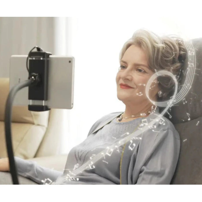 Woman relaxing in StarSleep Starise lift chair using phone holder and Bluetooth speaker feature