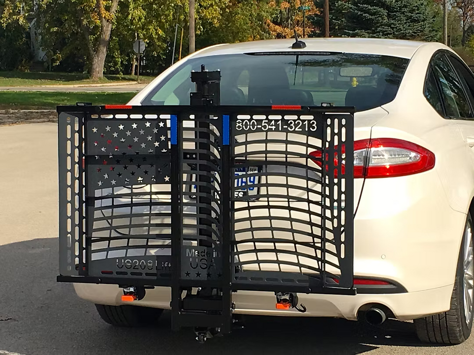 Wheelchair Carrier Patriotic electric scooter lift mounted on rear of white car